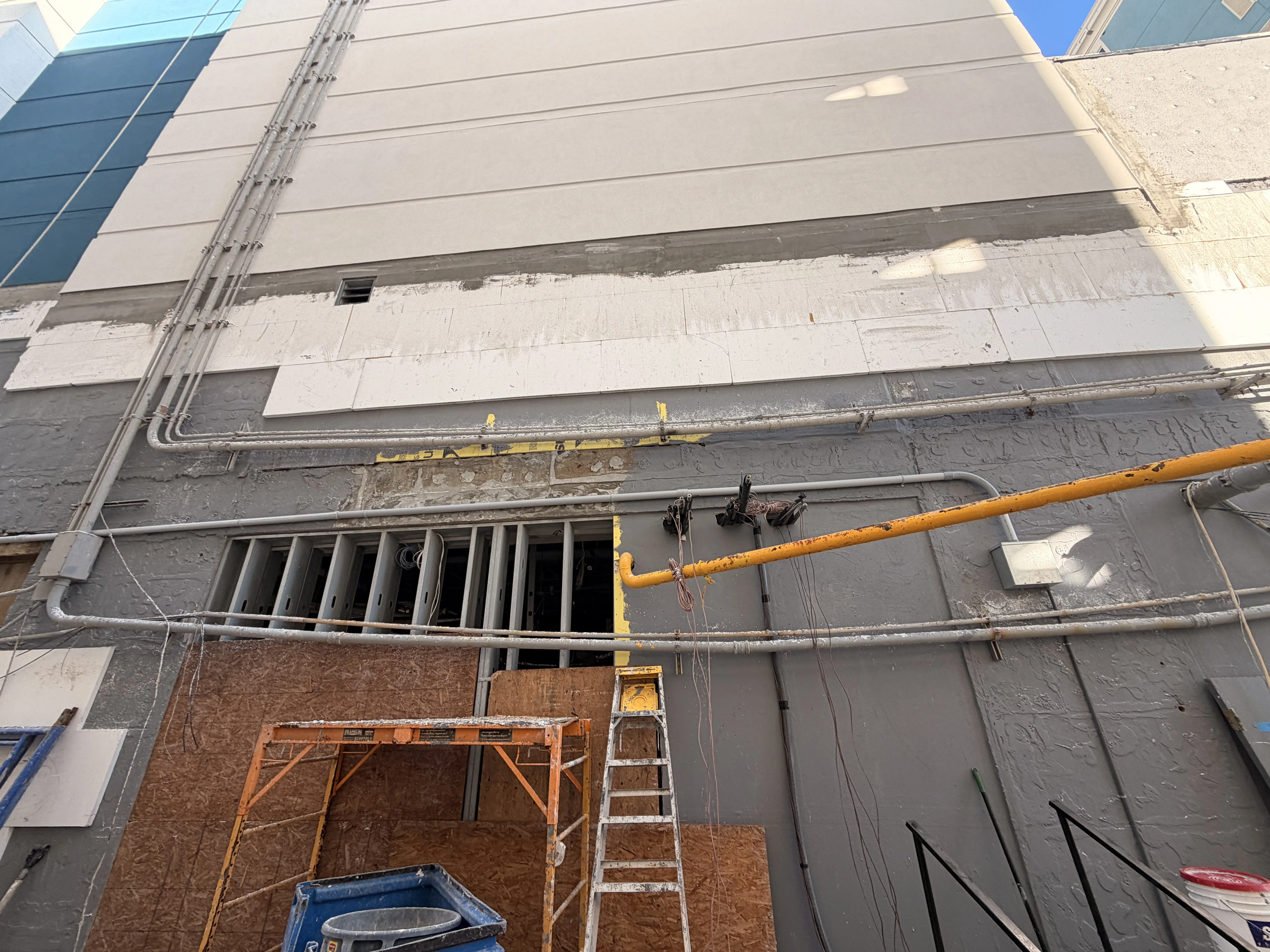 Exterior wall repair progress at a coastal commercial property