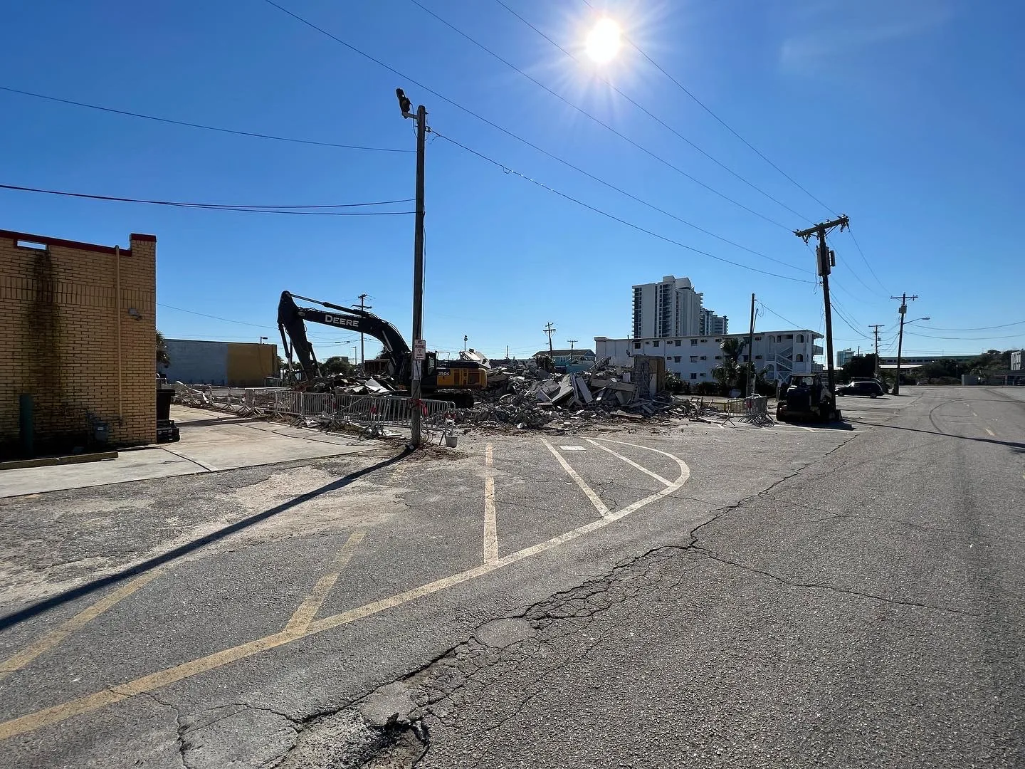 Excavator working through a street-front commercial structure