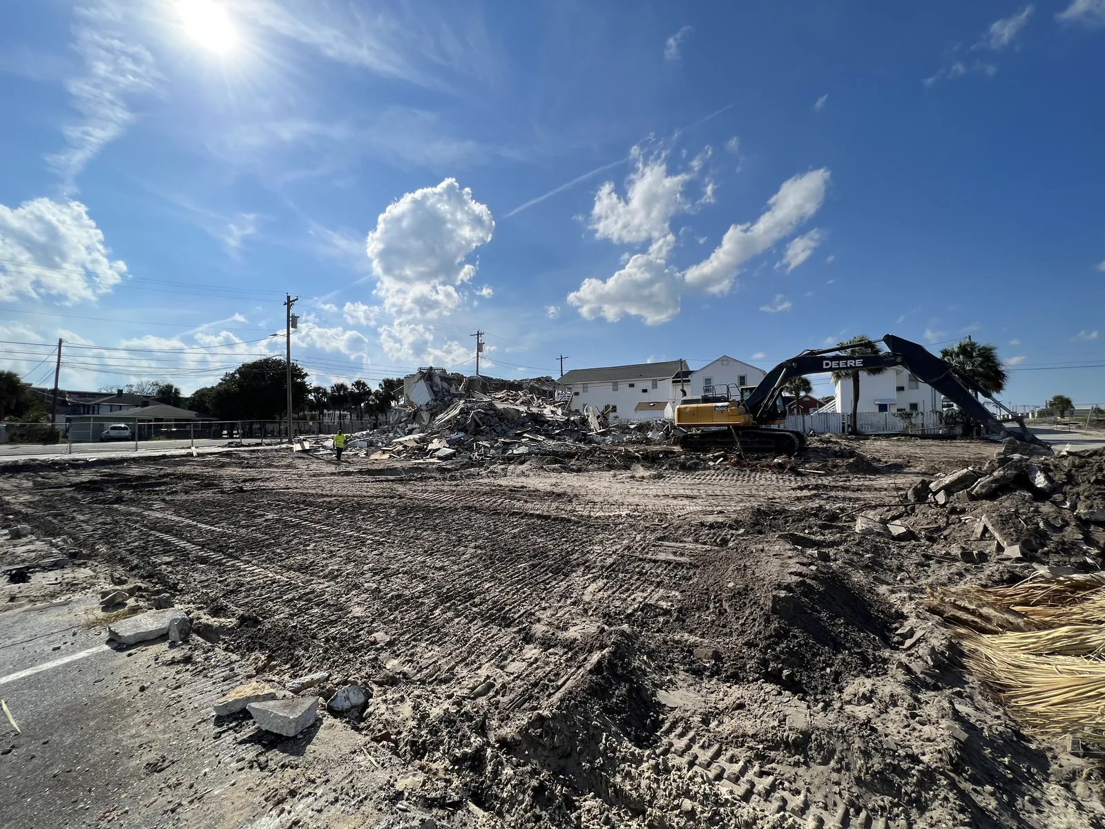 Large demolition site with debris staged for removal