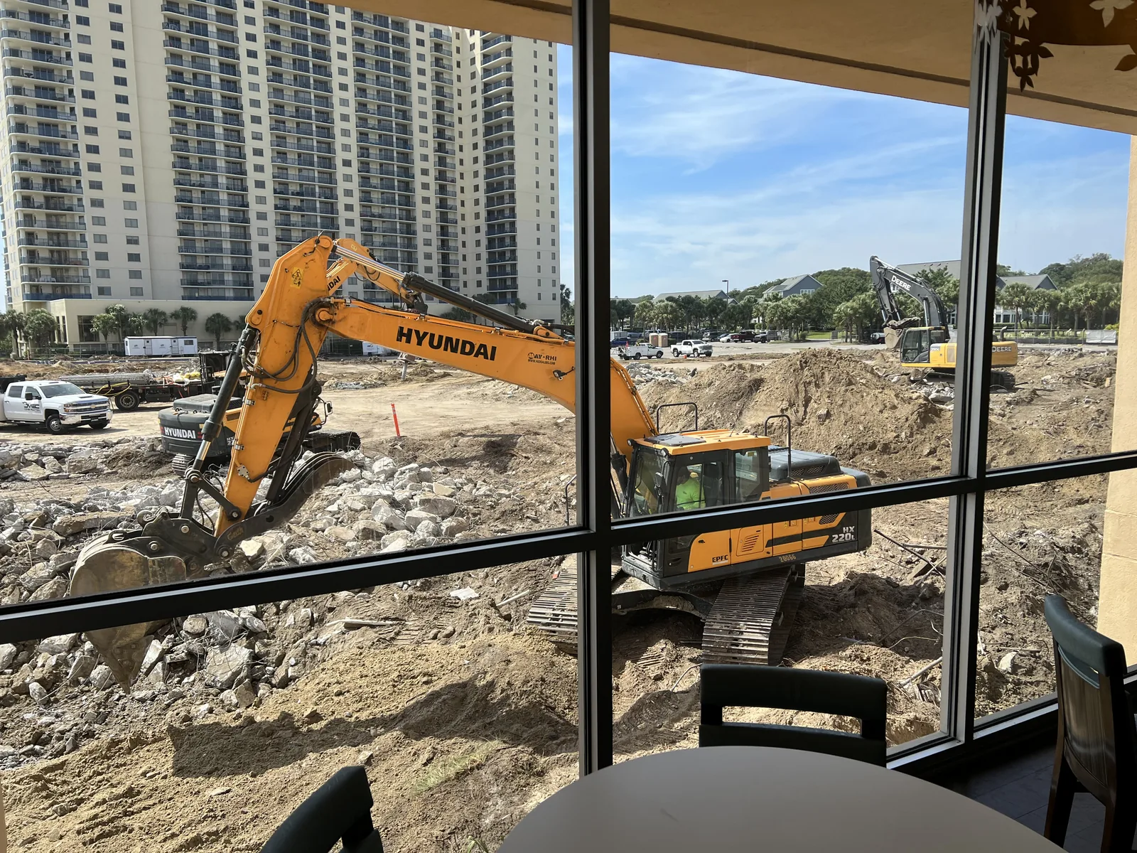 Excavators working across a large demolition site
