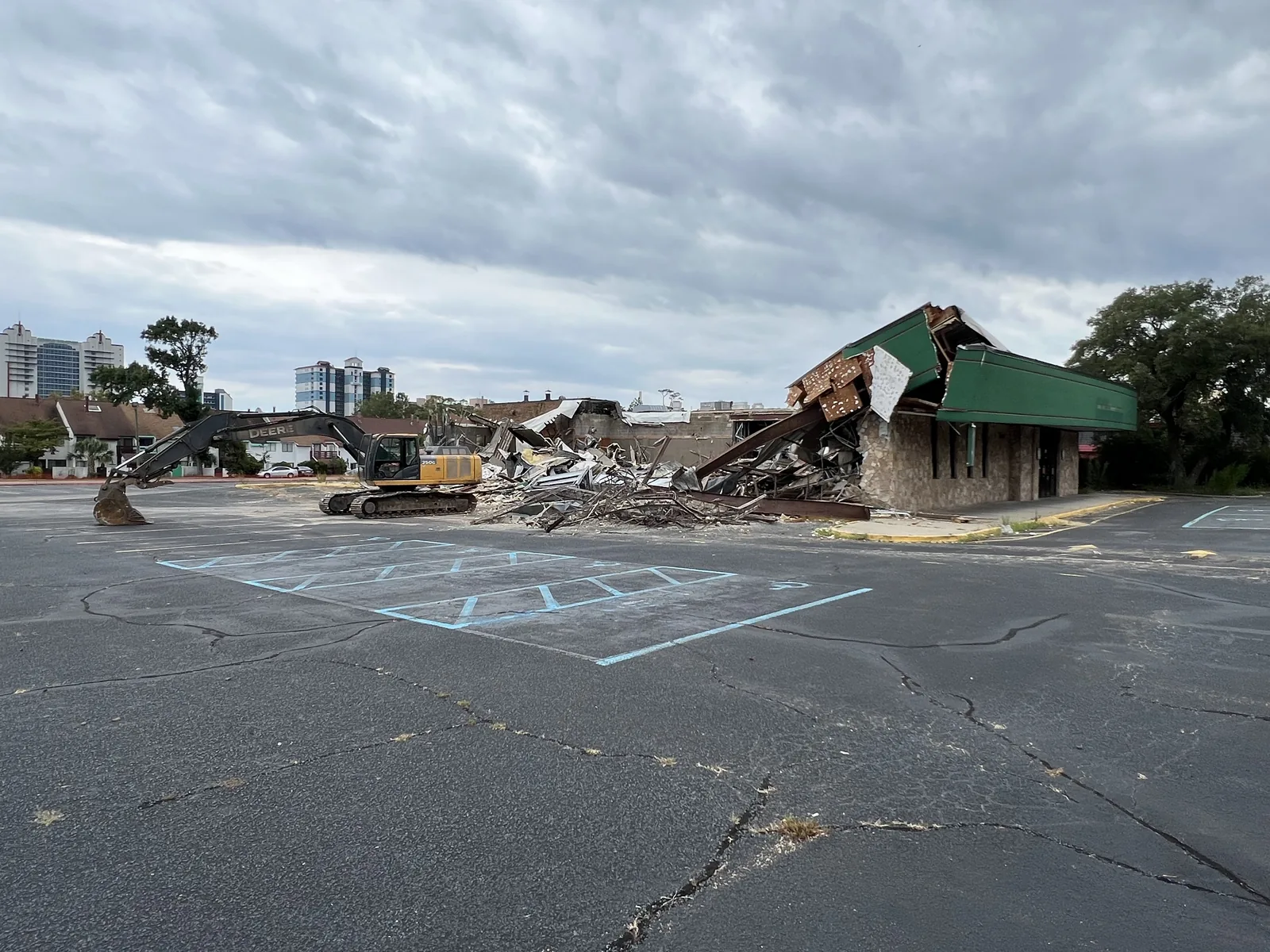 Large commercial structure during active demolition