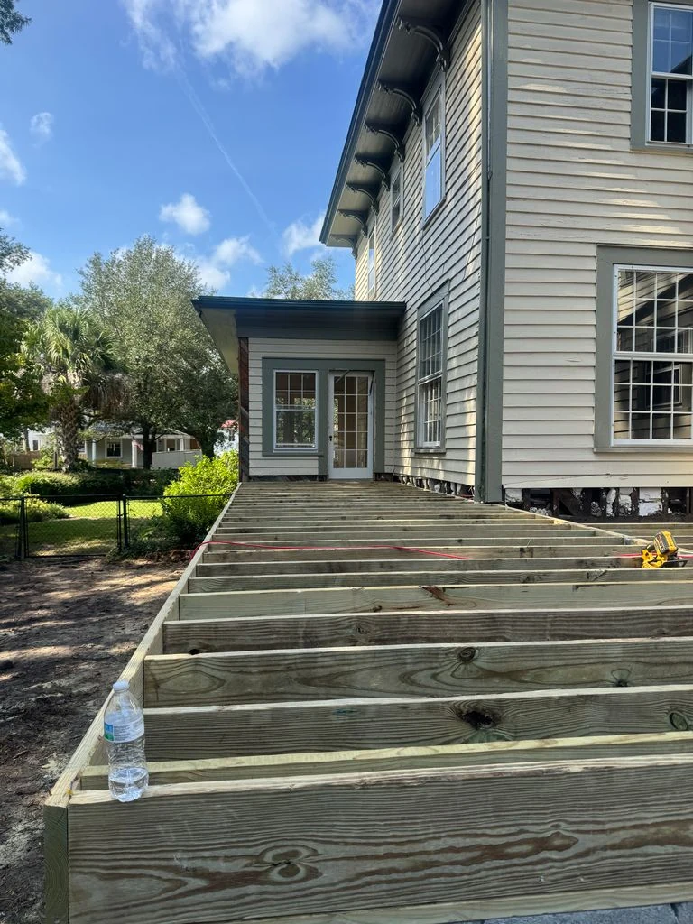 Pressure-treated floor framing under construction for a residential addition