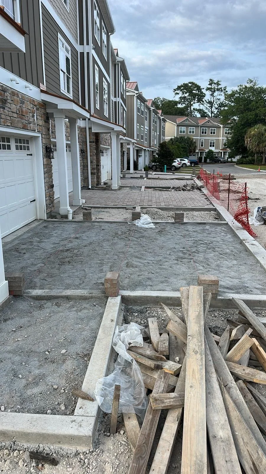 Driveway preparation and concrete paver installation at a multifamily residential property